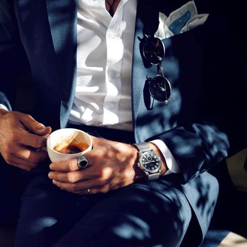 Cổ tay áo sơ mi trắng lộ nhẹ ngoài tay áo vest xanh navy đúng chuẩn măng sét